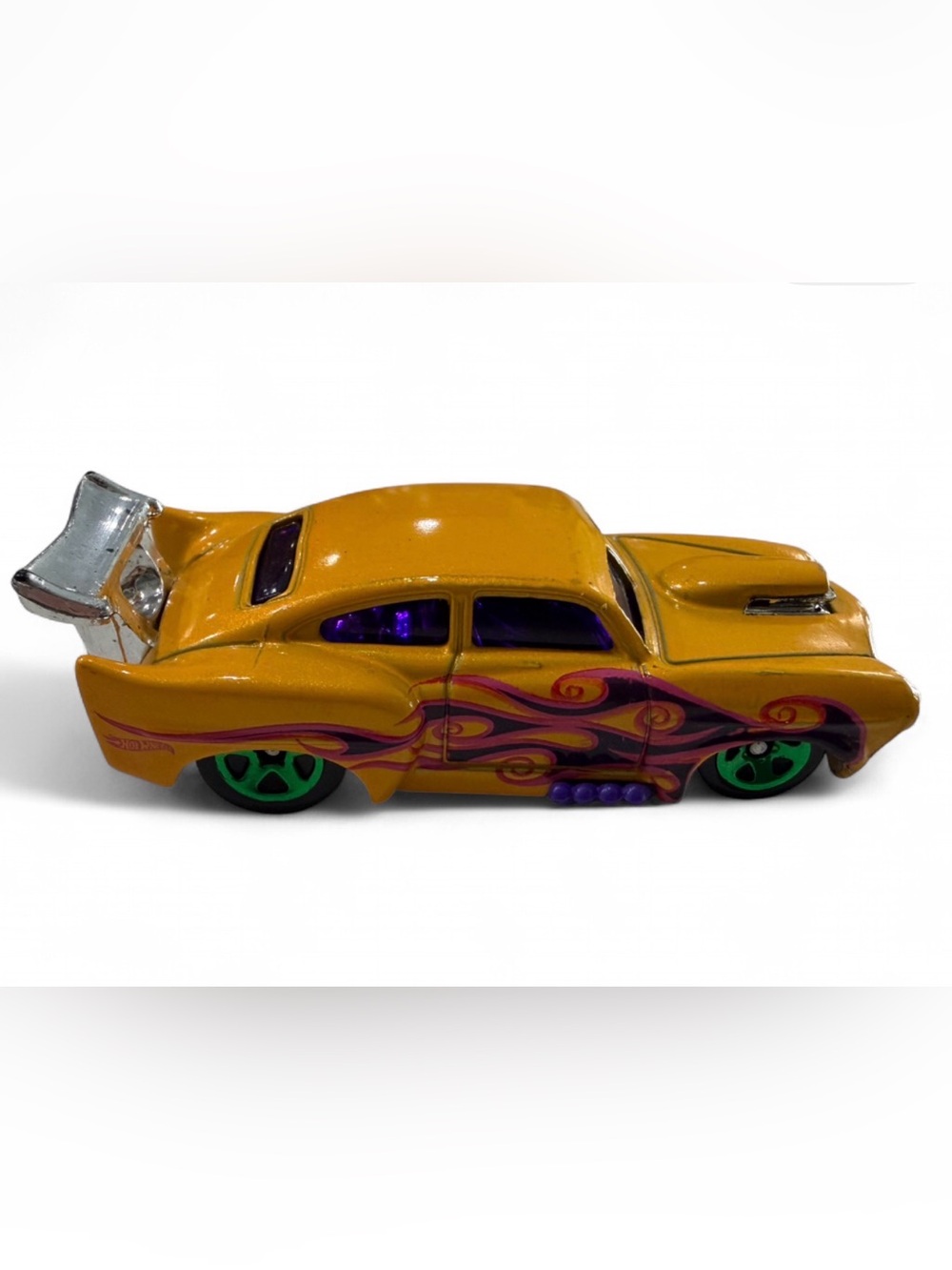 Yellow Die-Cast Toy Race Car with Purple Flames and Green Wheels